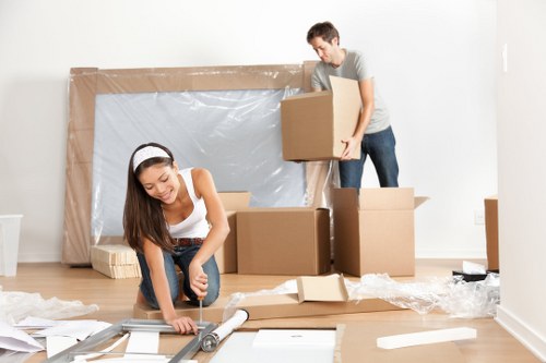 Professional movers loading packed boxes and furniture