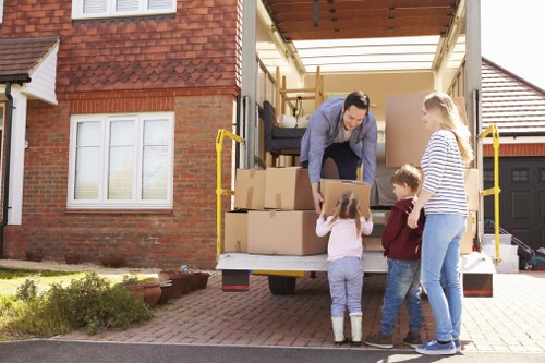 Moving crew handling furniture and boxes with attention to detail during a Finsbury Park relocation