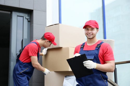 Local office moving crew transporting desks and files in North London