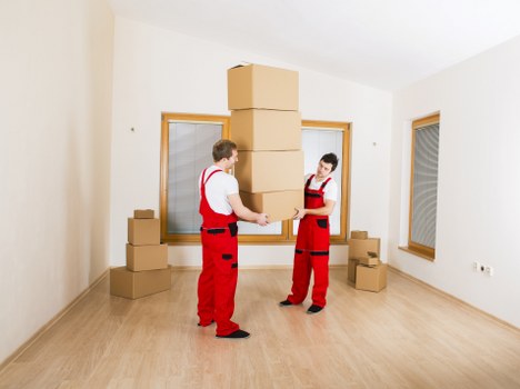 Local removals team handling furniture in a Finsbury Park flat